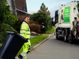 Skraldemand tømmer affaldsbeholder